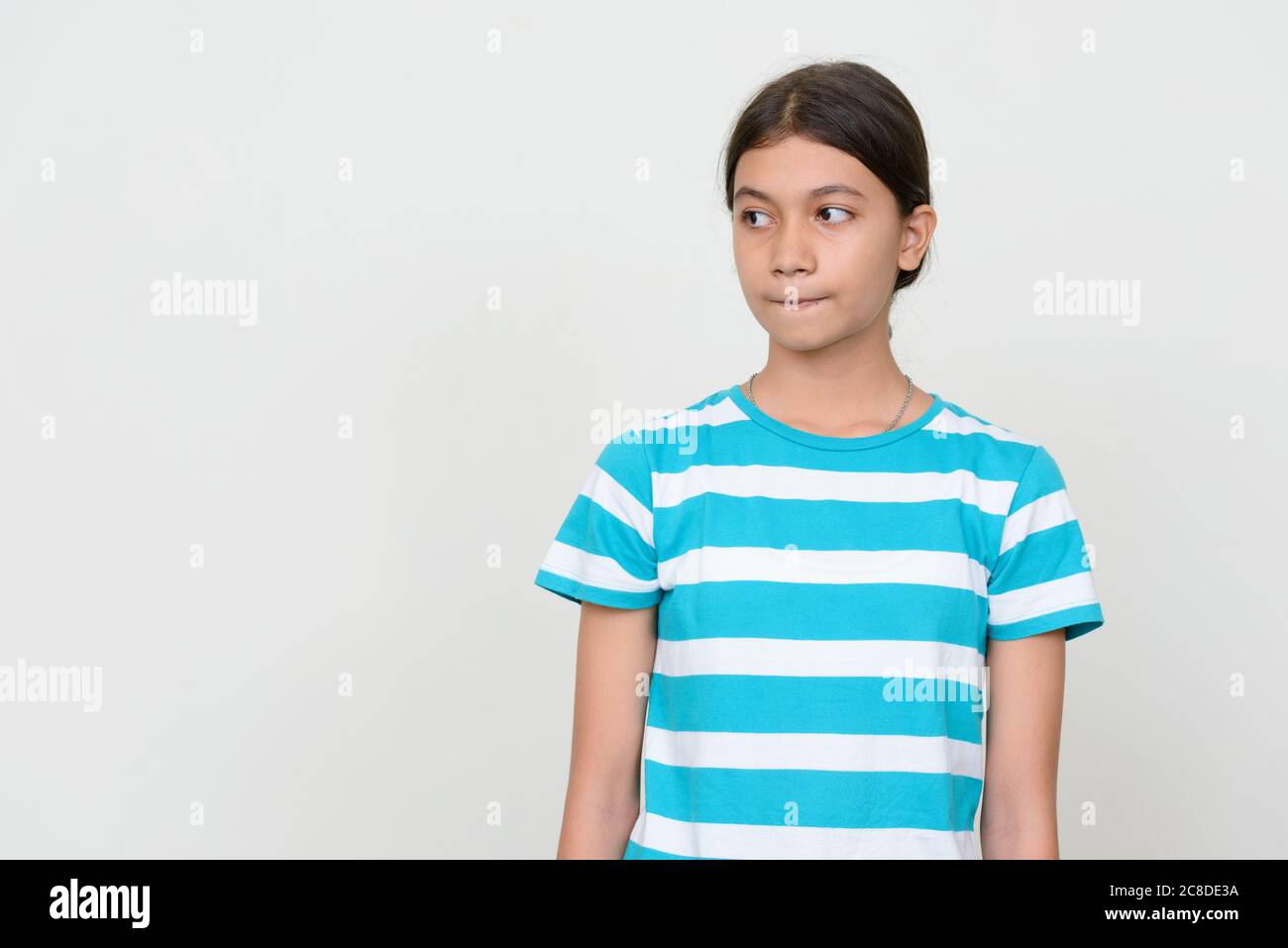 Portrait of young Asian teenage girl against white background Stock ...