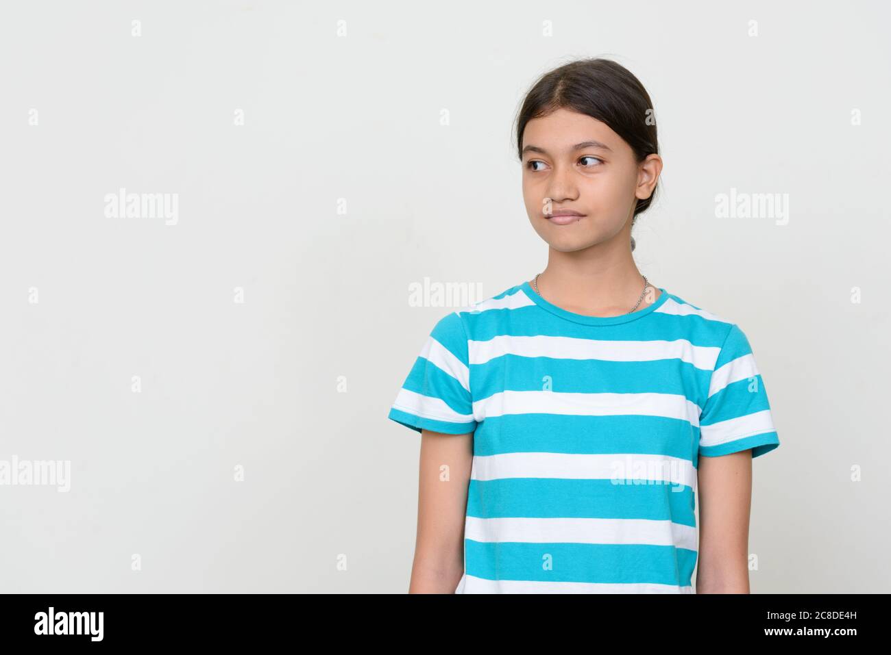 Portrait of young Asian teenage girl against white background Stock ...