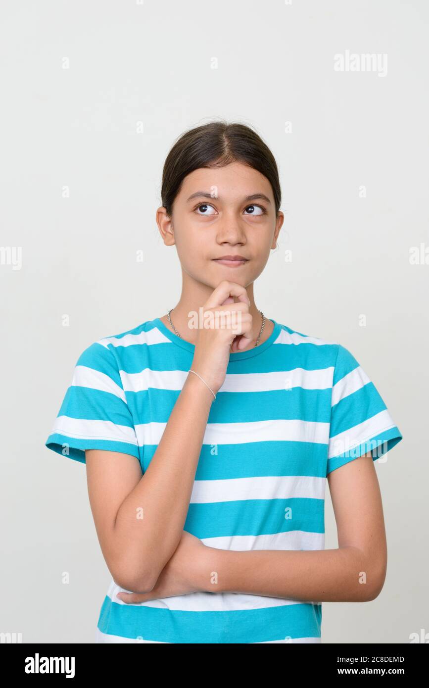 Portrait of young Asian teenage girl against white background Stock ...