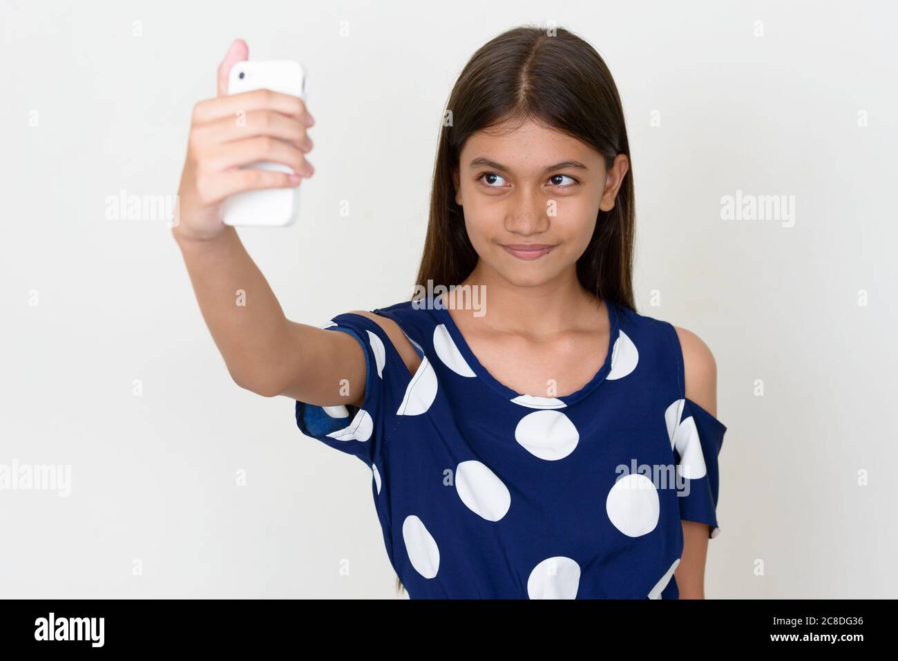 Portrait of young Asian teenage girl against white background Stock ...