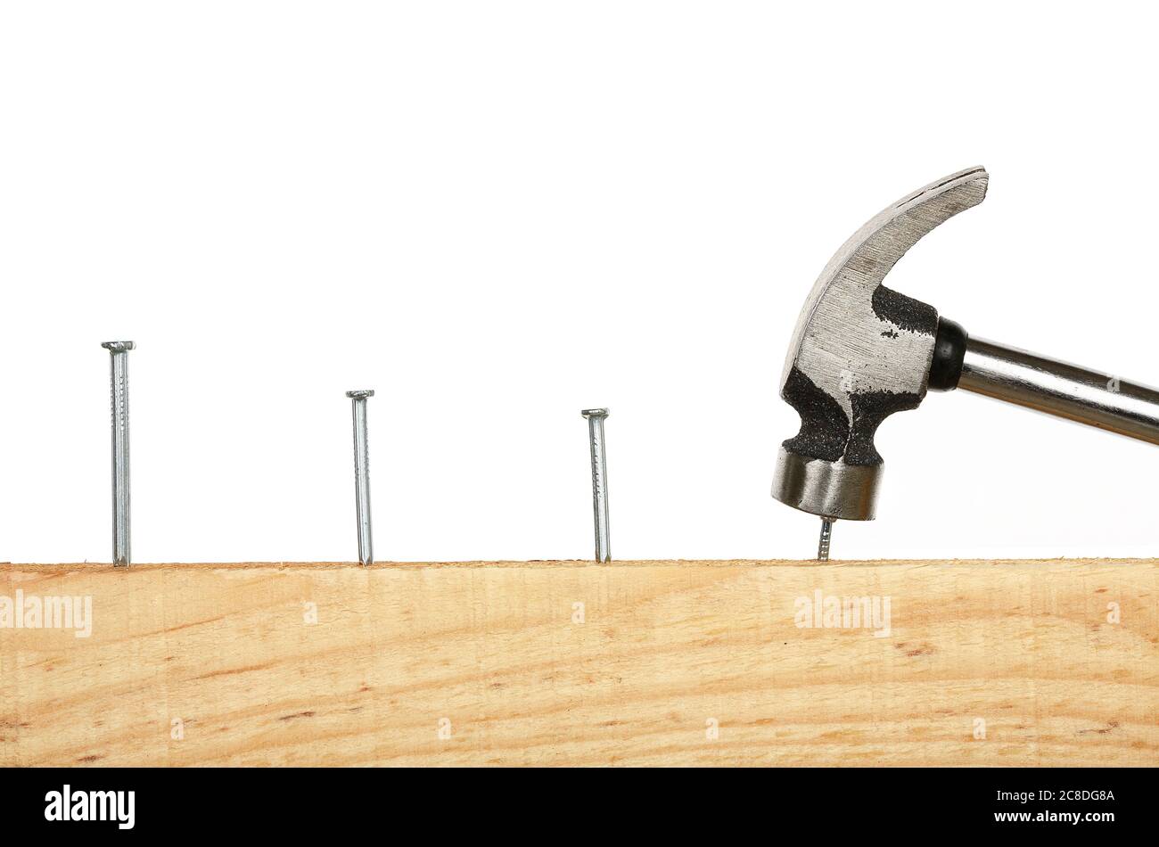 consecutive nails on wood and hammer Stock Photo