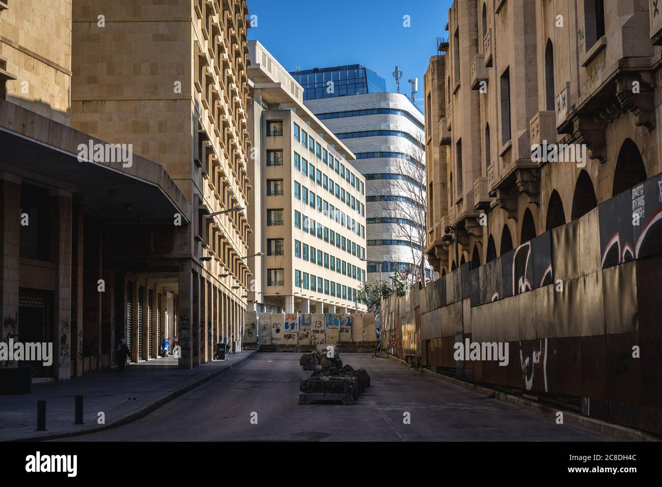 Street barricades on Syria Street left after October Revolution - 2019-2020 protests in Beirut, Lebanon, abandoned Grand Theatre on right Stock Photo