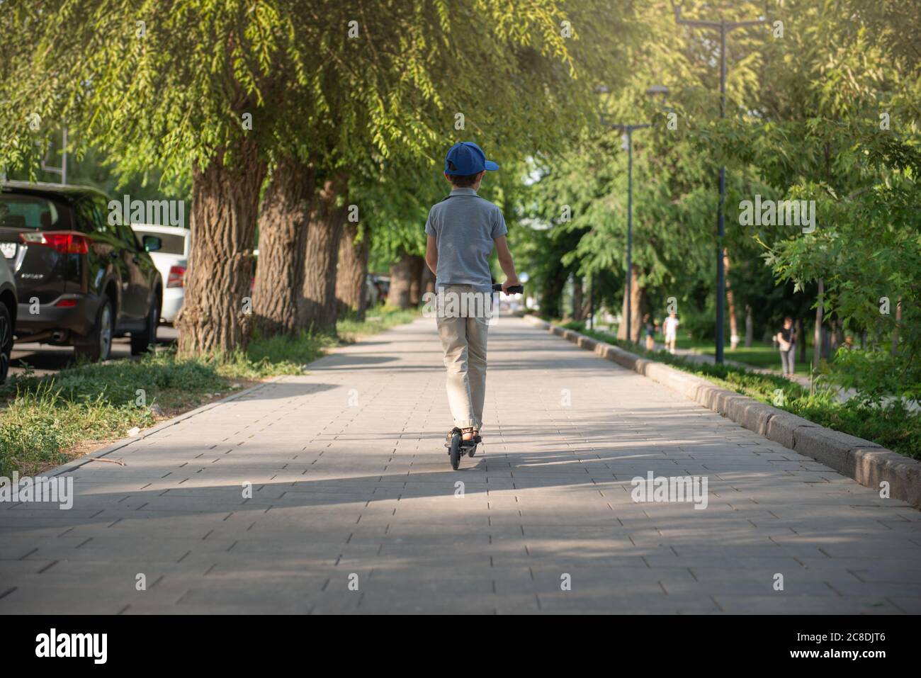 boy in the park riding a scooter Stock Photo