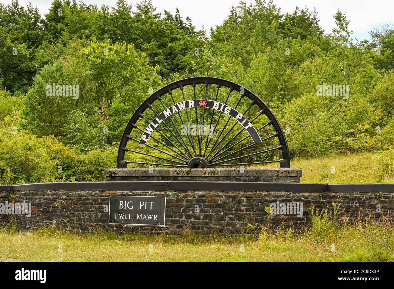 Blaenavon, Wales - July 2020: Old pit winding wheel at the entrance to the Big Pit museum in Blaenavon. It is a popular visitor attraction showing the Stock Photo
