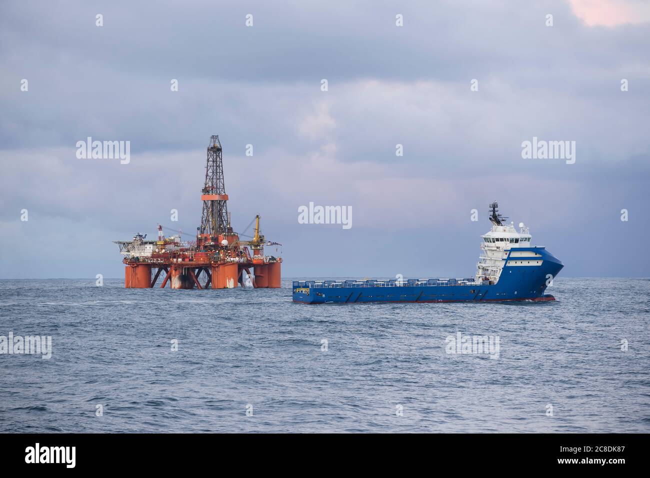 Drilling rig and supply ship Stock Photo Alamy