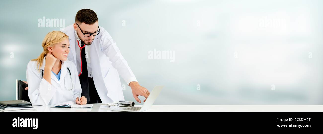 Doctors working with laptop computer in hospital Stock Photo Alamy