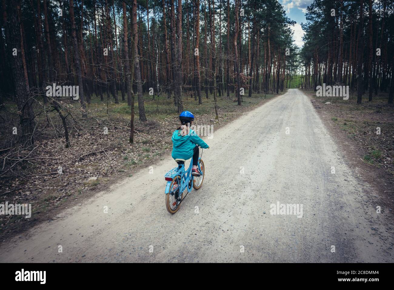 8 years girl riding bike in forest near Minsk Mazowiecki n the Masovian Voivodeship in central Poland Stock Photo