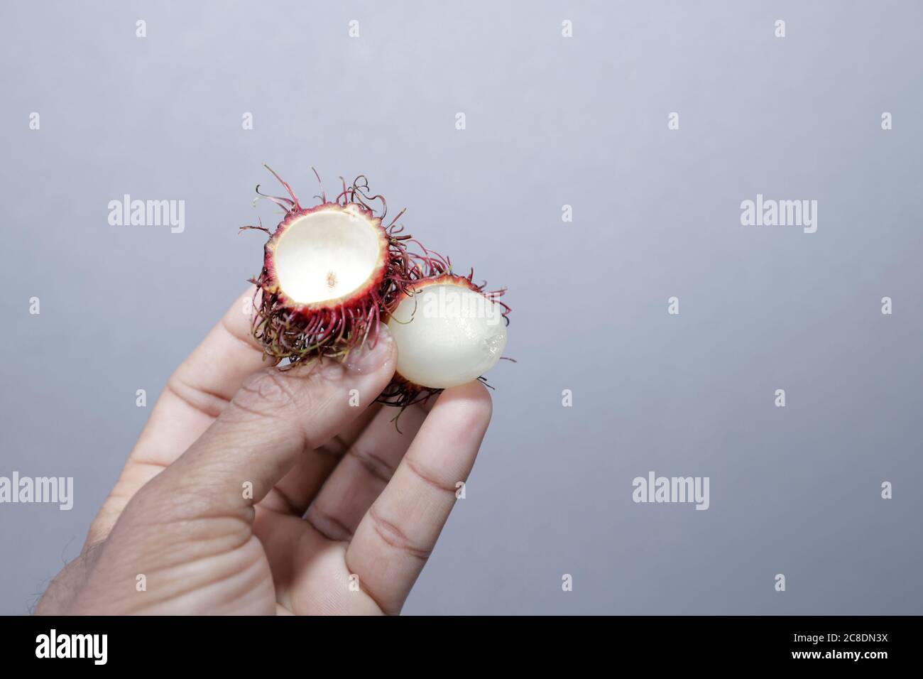 How To Open Rambutan Open Rambutan exotic fruit in hand Stock Photo - Alamy