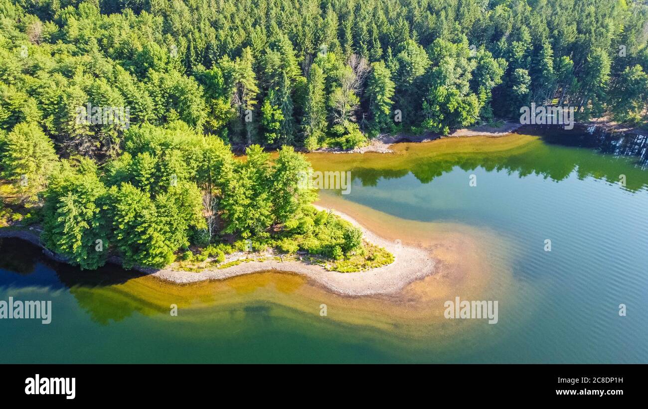 Scenic aerial view of a blue lake with pine trees coast line Stock ...