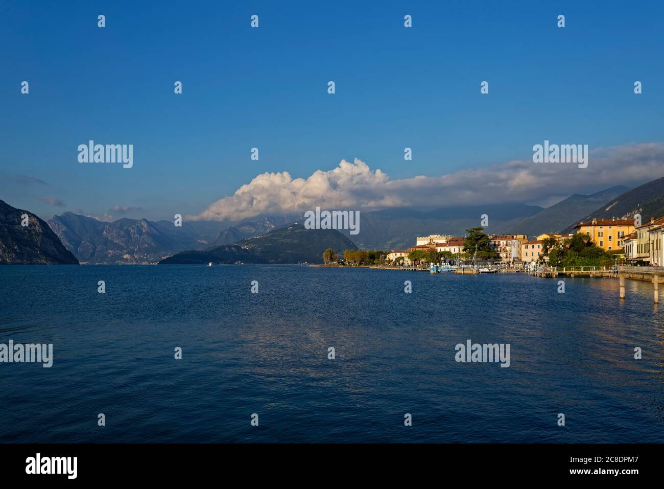 Italy, Lombardy, Lake Iseo and town at sunset Stock Photo