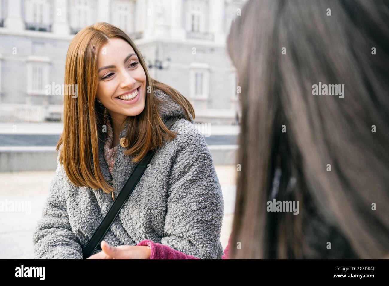 Two young woman sitting in hi-res stock photography and images - Alamy