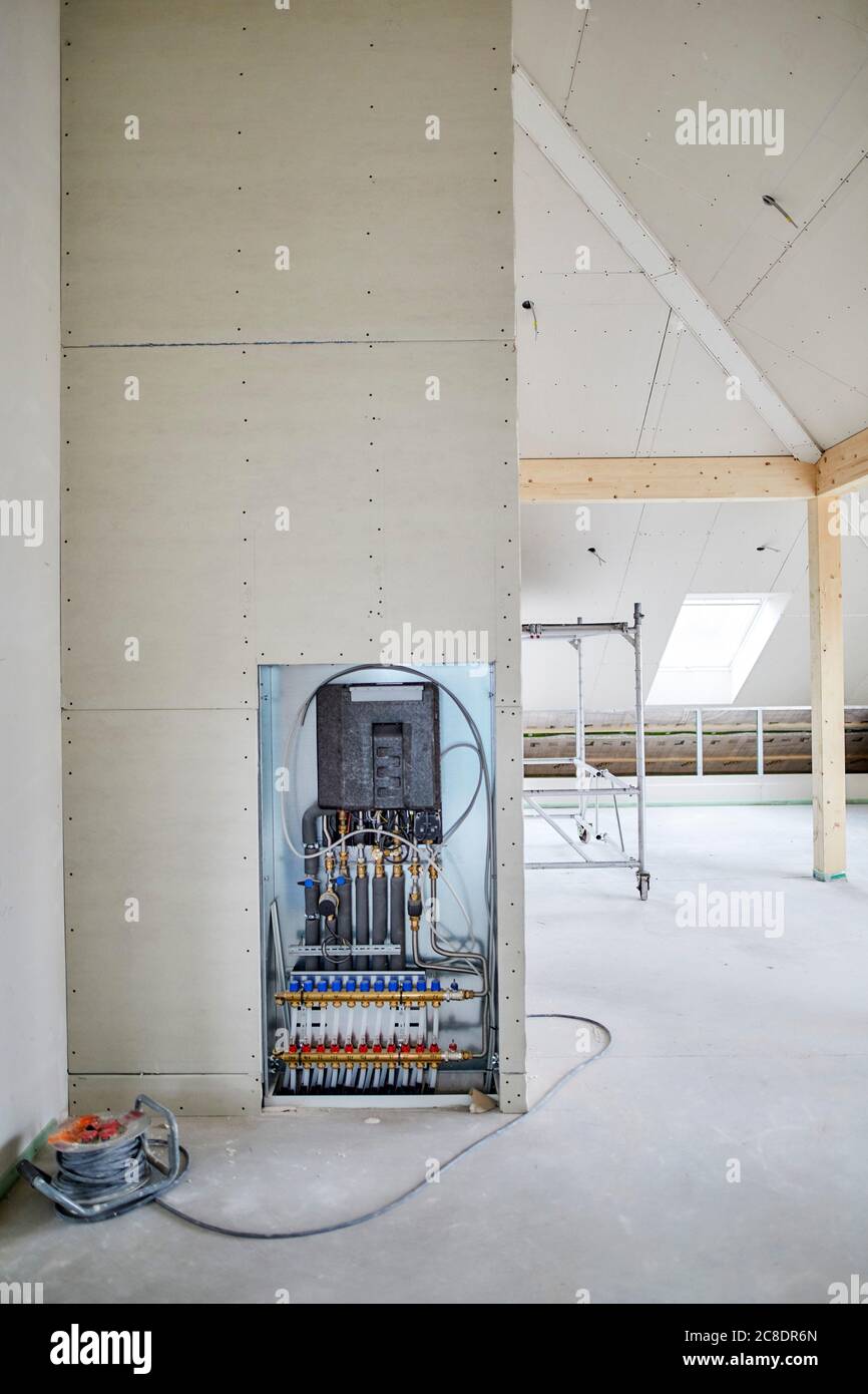 Cable extension reel and conduit for underfloor heating on construction site Stock Photo