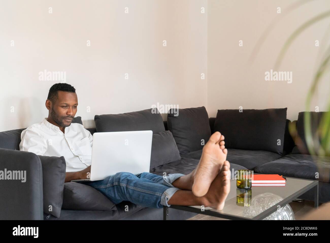 Man sitting with feet up on table hi-res stock photography and images -  Alamy