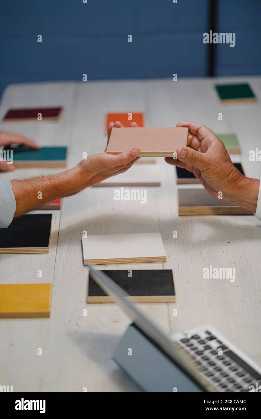 Hands of architects choosing colour samples in office Stock Photo
