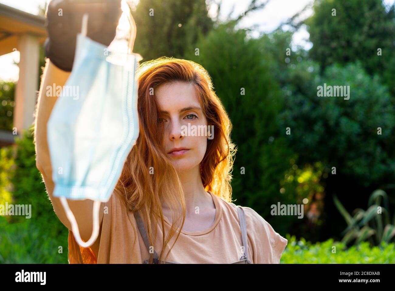 Woman in face mask holding hi-res stock photography and images - Alamy