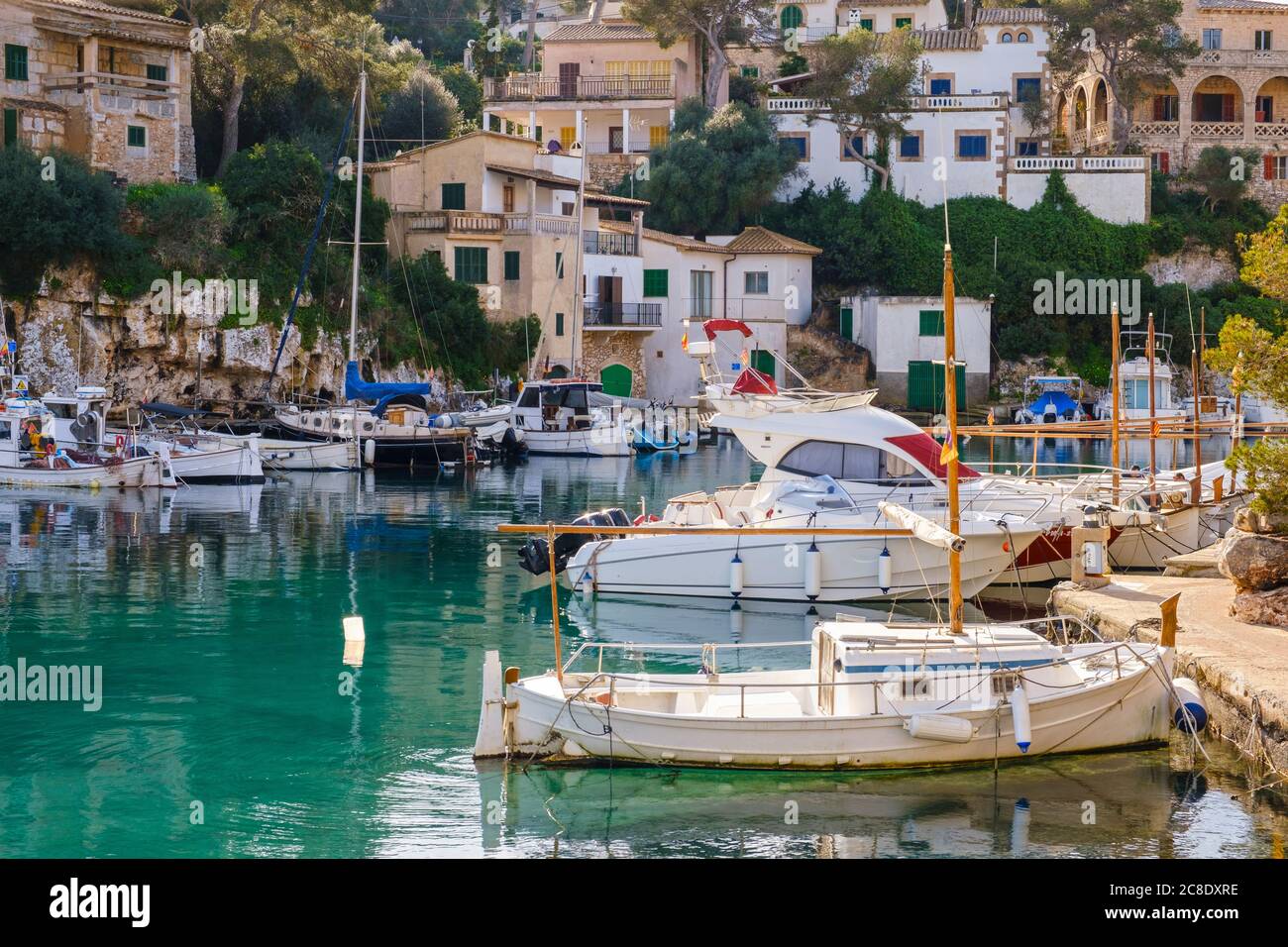 Spain, Mallorca, Santanyi, Boats moored in harbor of coastal village in summer Stock Photo