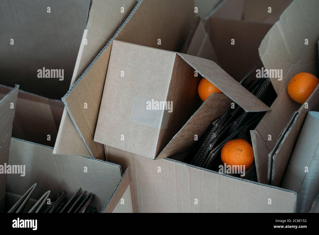 Three oranges on cardboard boxes Stock Photo