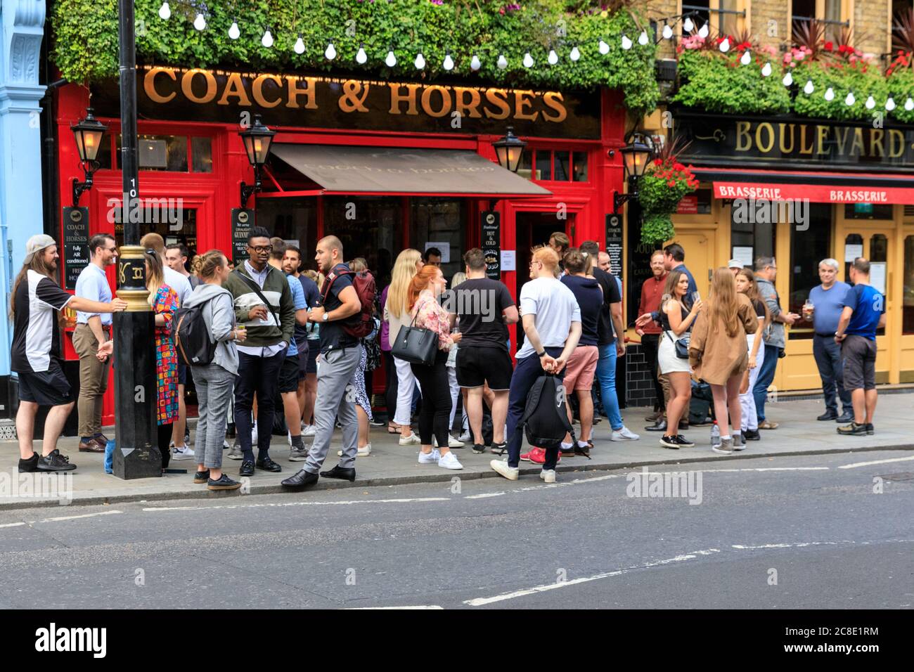 London, UK. 23rd July, 2020. A fairly large number of people drink and chat outside a pub in London's popular Covent Garden area, making social distancing effectively impossible. Credit: Imageplotter/Alamy Live News Stock Photo