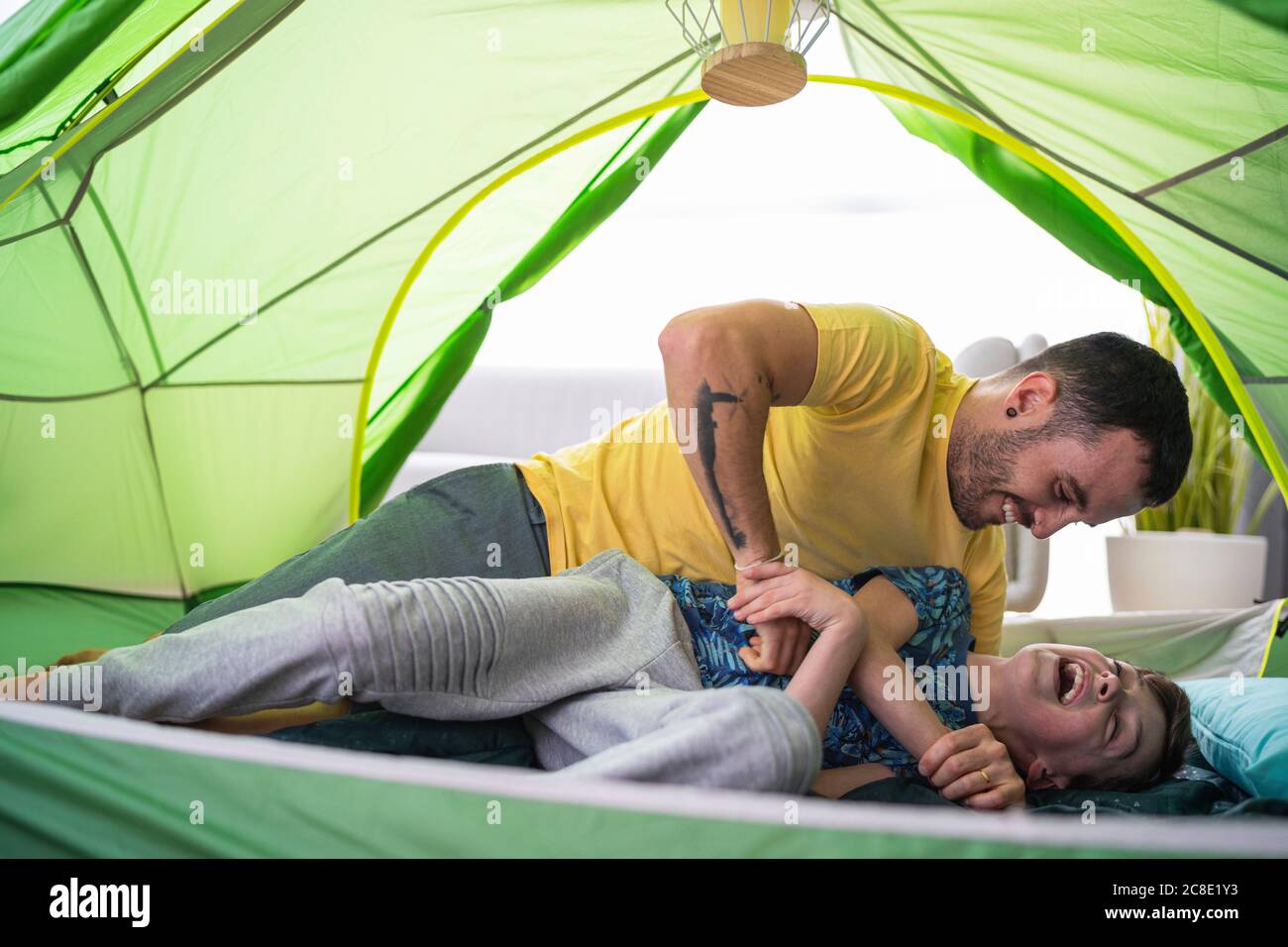 Father and son playing in tent at home Stock Photo - Alamy