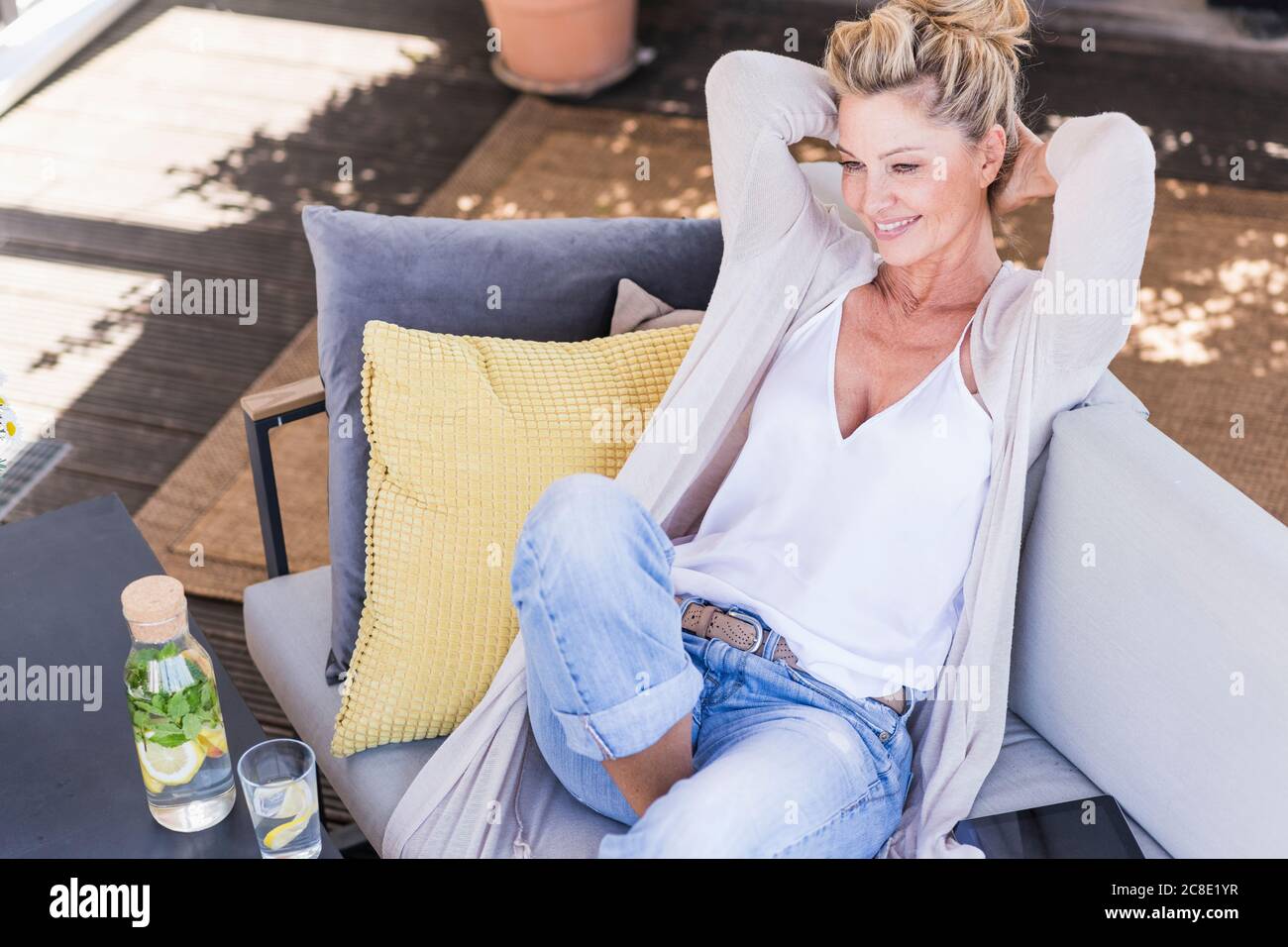 Portrait of smiling mature woman relaxing on terrace Stock Photo - Alamy