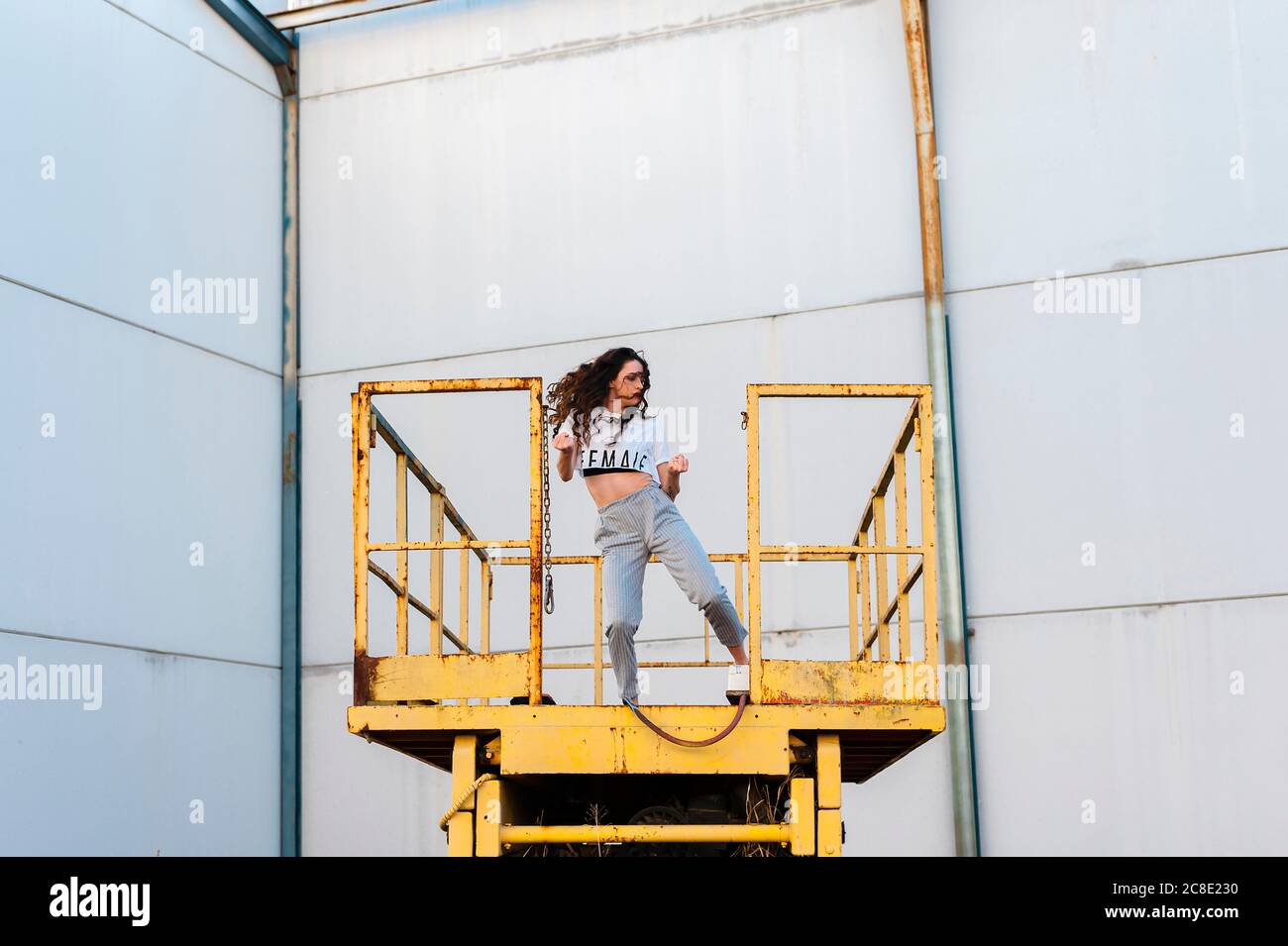 Female hip-hop dancer dancing on metallic platform in abandoned building Stock Photo
