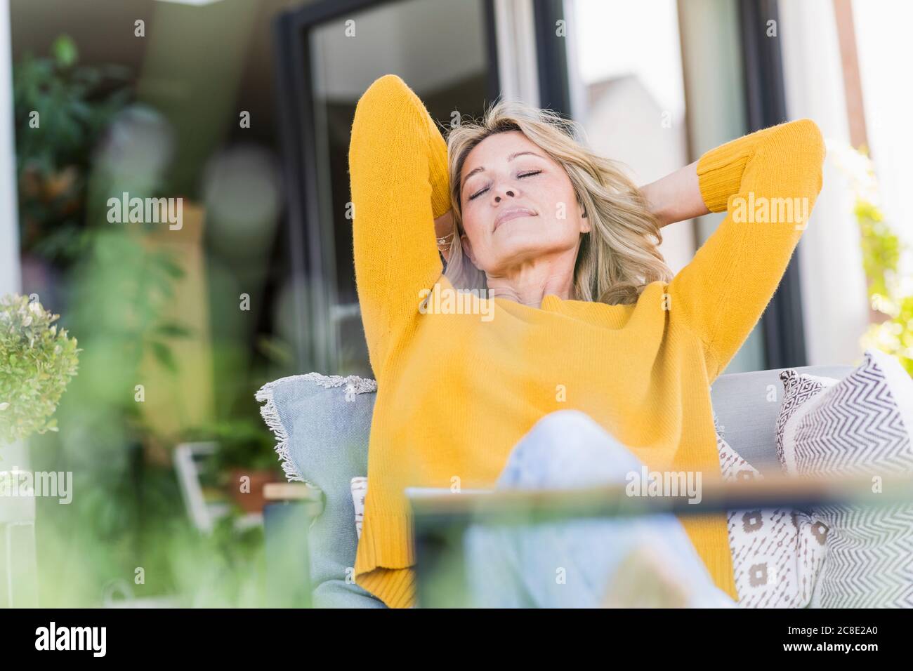 Portrait of mature woman with eyes closed relaxing on terrace Stock ...
