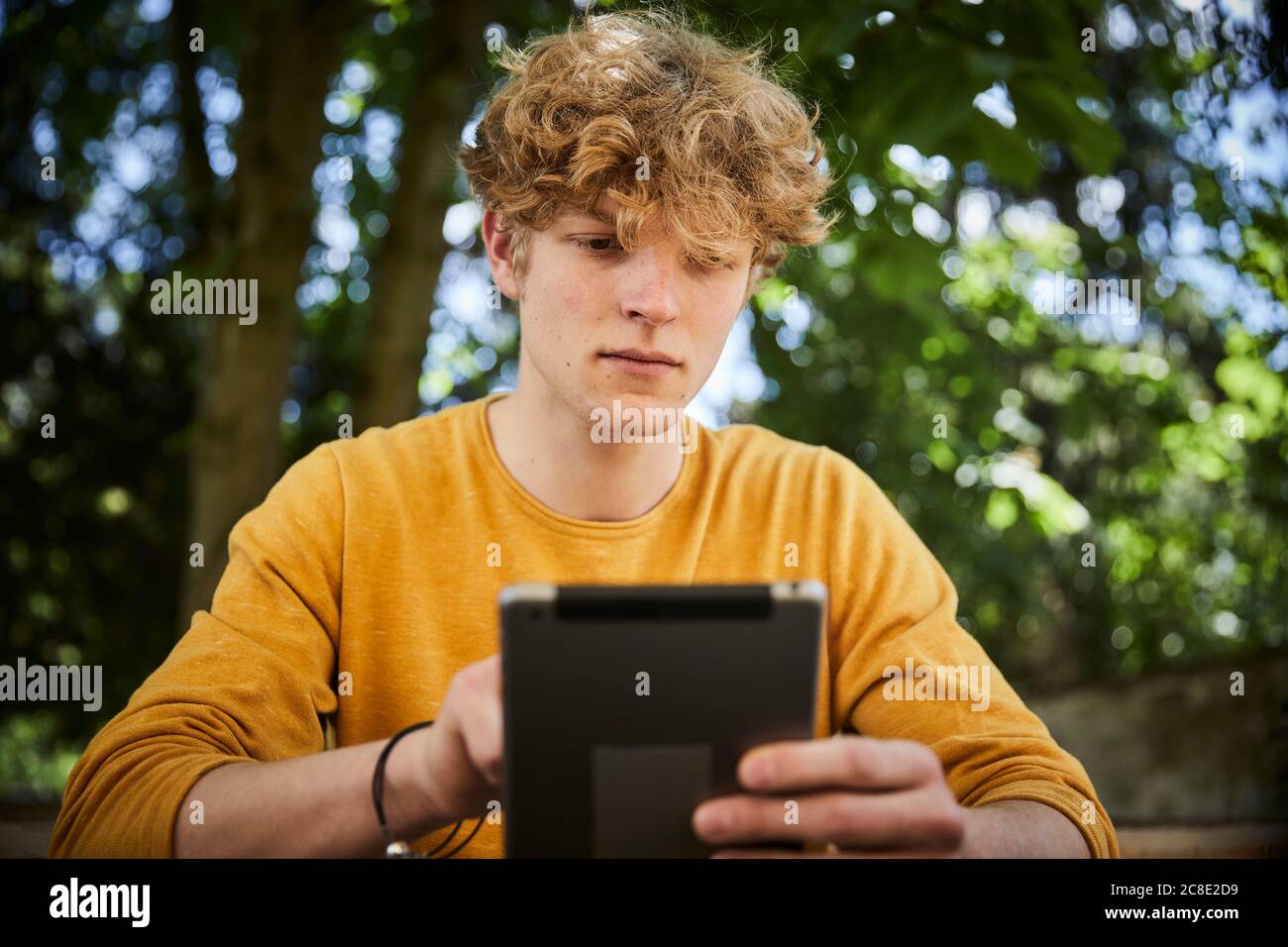 Portrait of young man using digital tablet outdoors Stock Photo