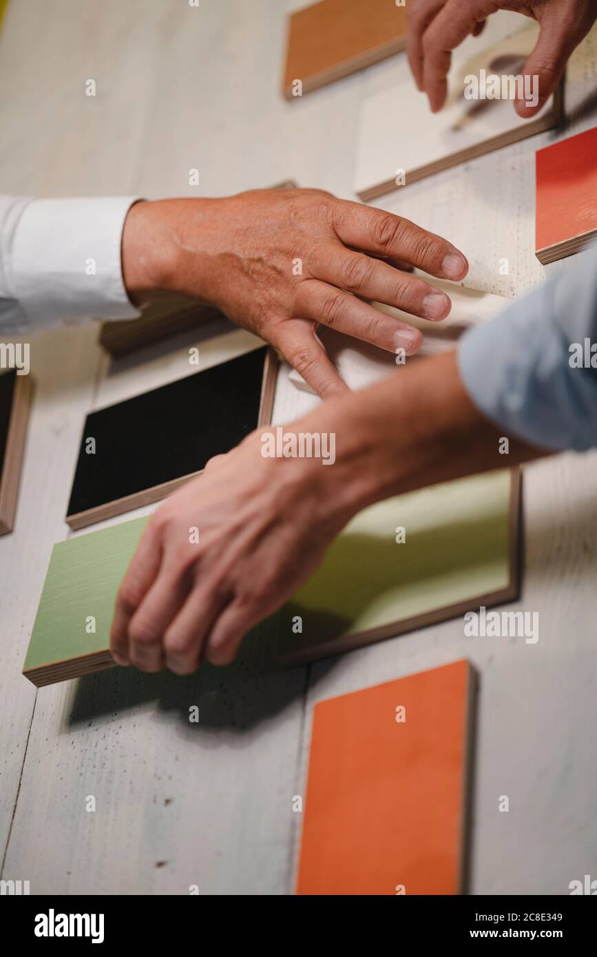 Hands of architects choosing colour samples in office Stock Photo
