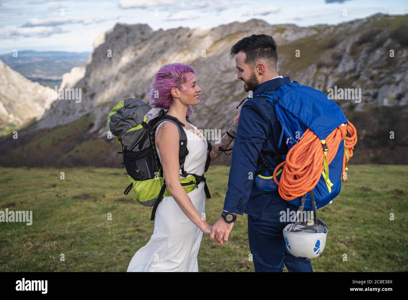 Bridal couple with climbing backpacks at Urkiola mountain, Spain Stock Photo