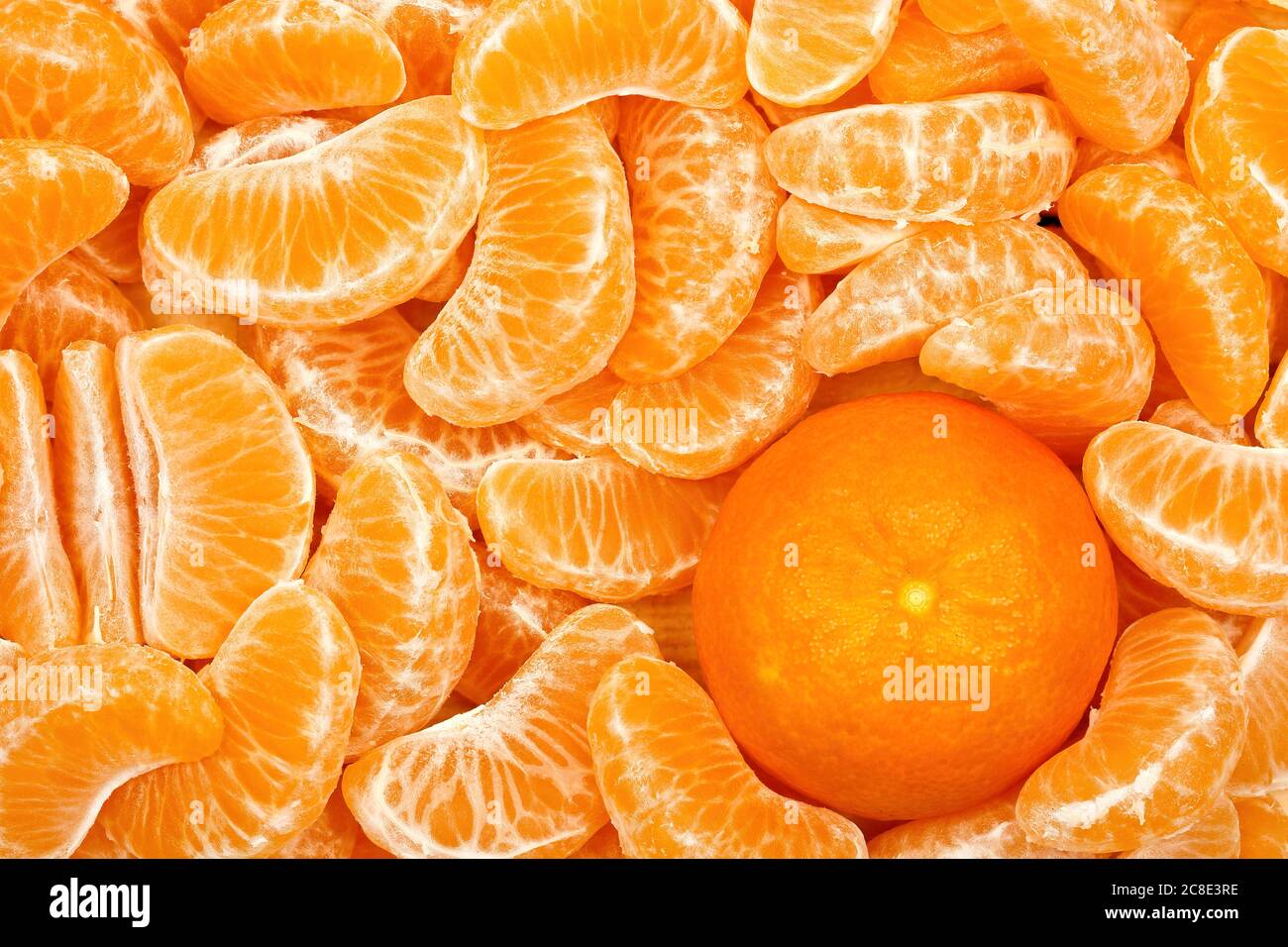 mandarine orange among mandarine slices Stock Photo