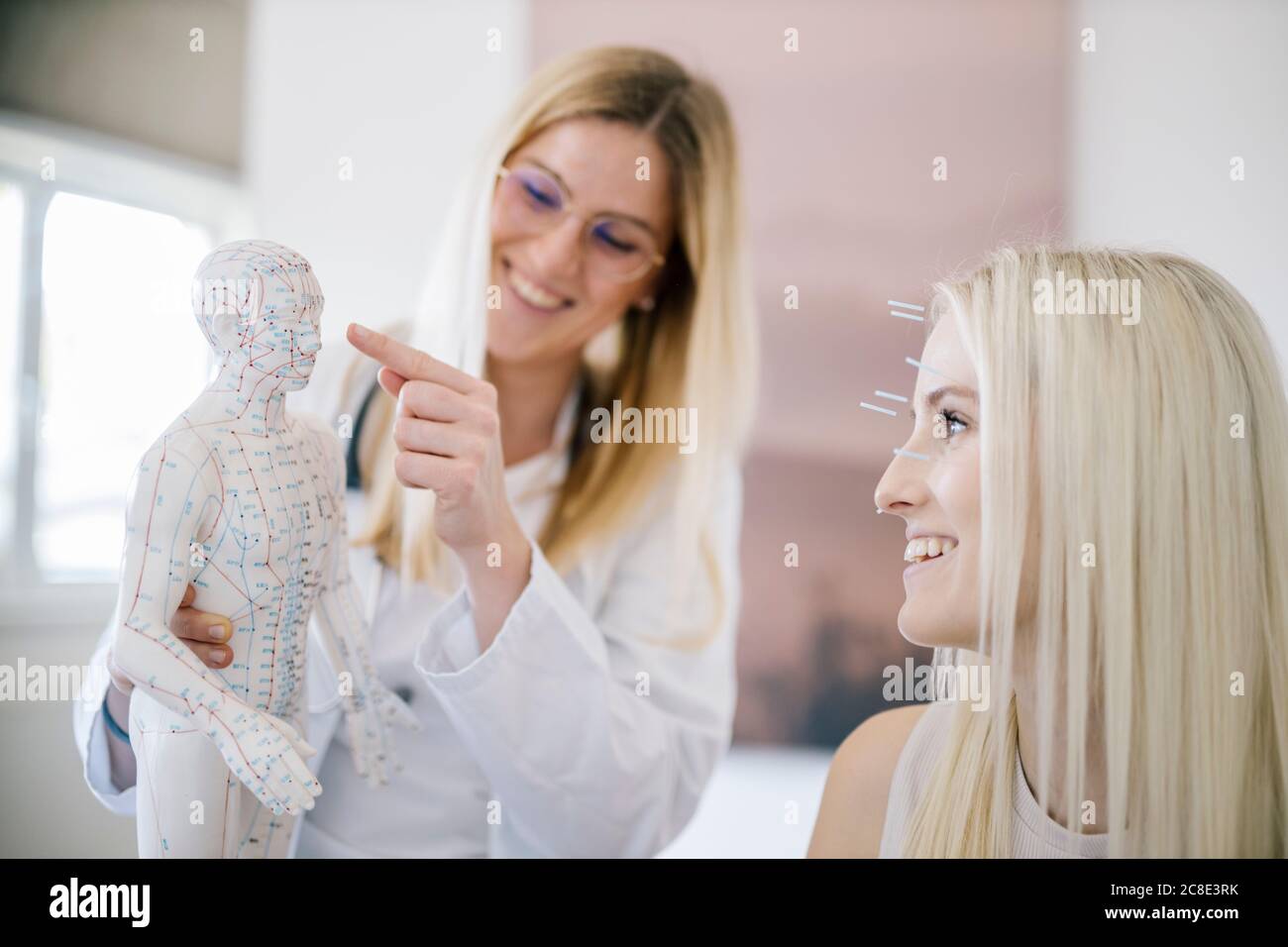 Doctor showing acupuncture point at model hires stock photography and