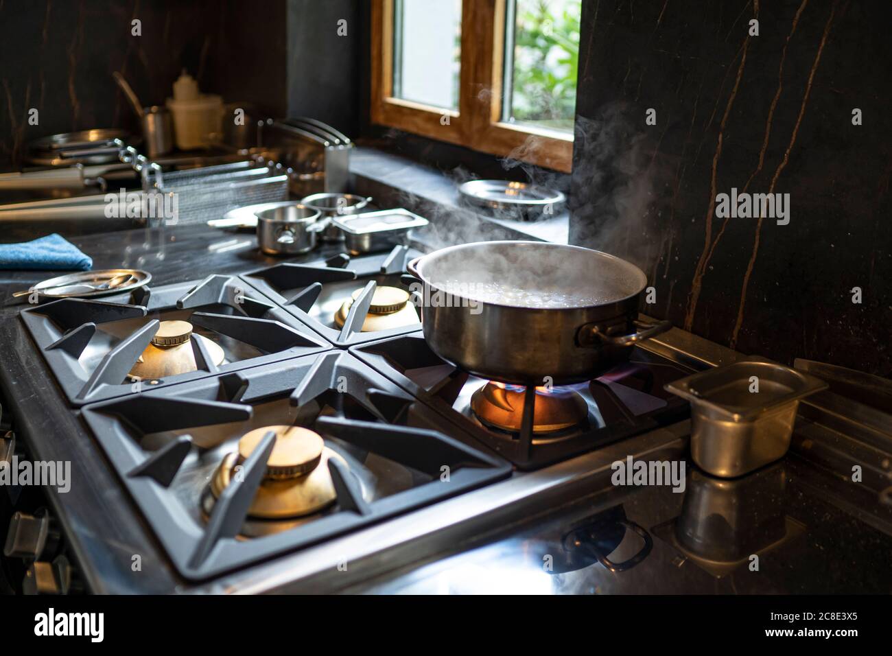 Cooking pot on gas stove in restaurant kitchen Stock Photo