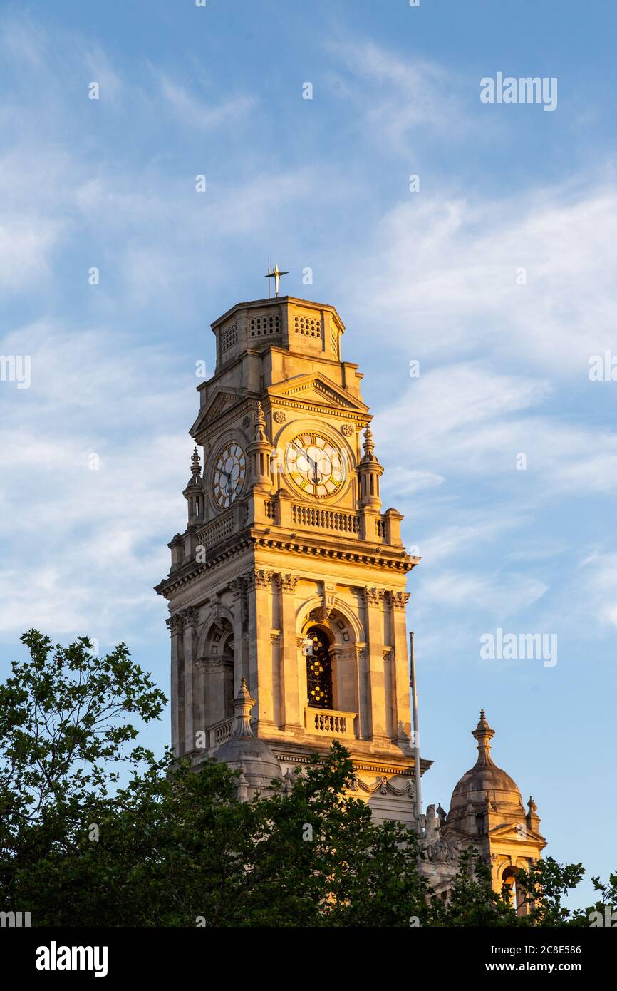 Light hitting the clock tower of Portsmouth Guildhall during sunrise