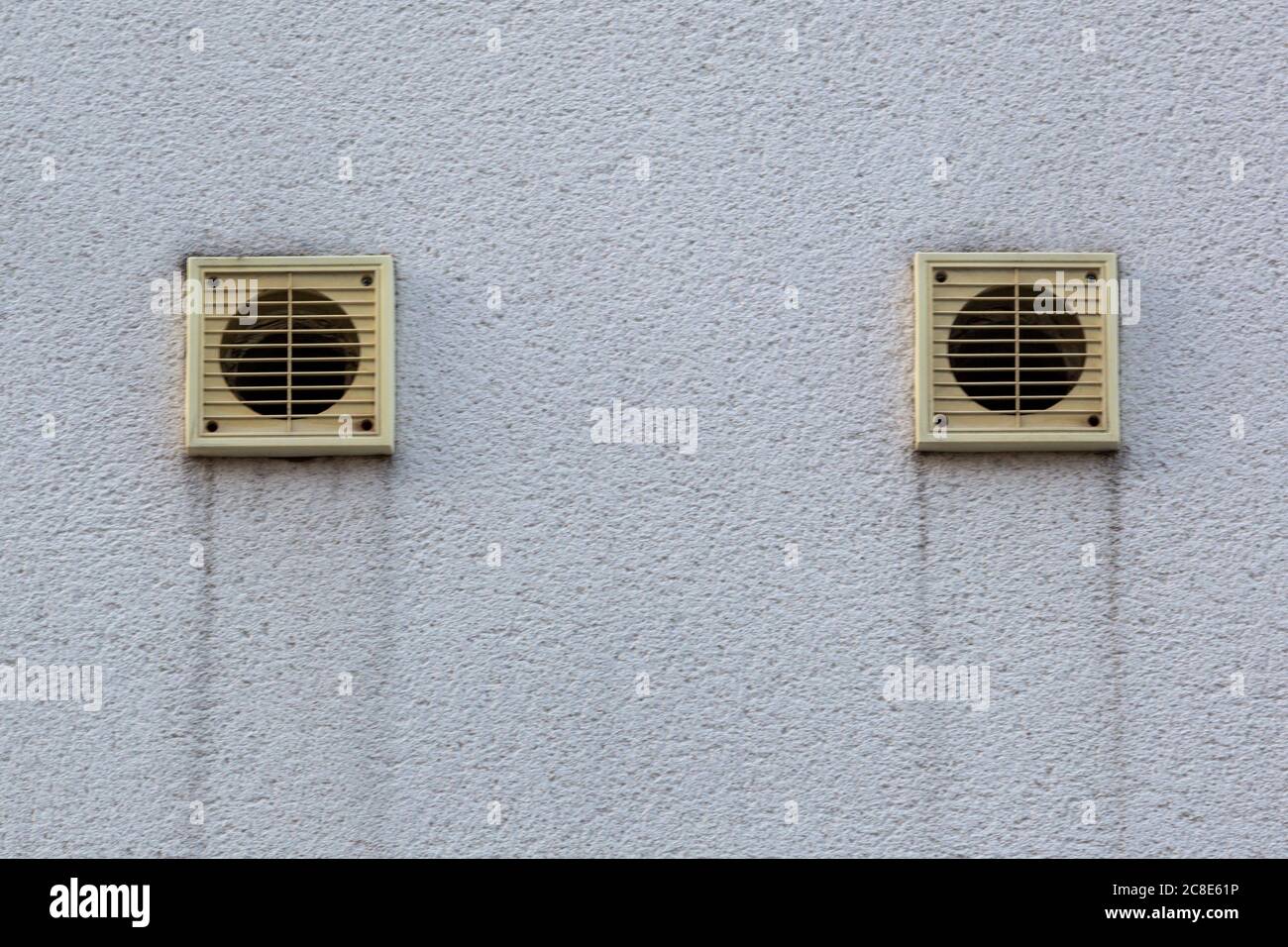 Two central heating or tumble dryer air vent in the side of a building
