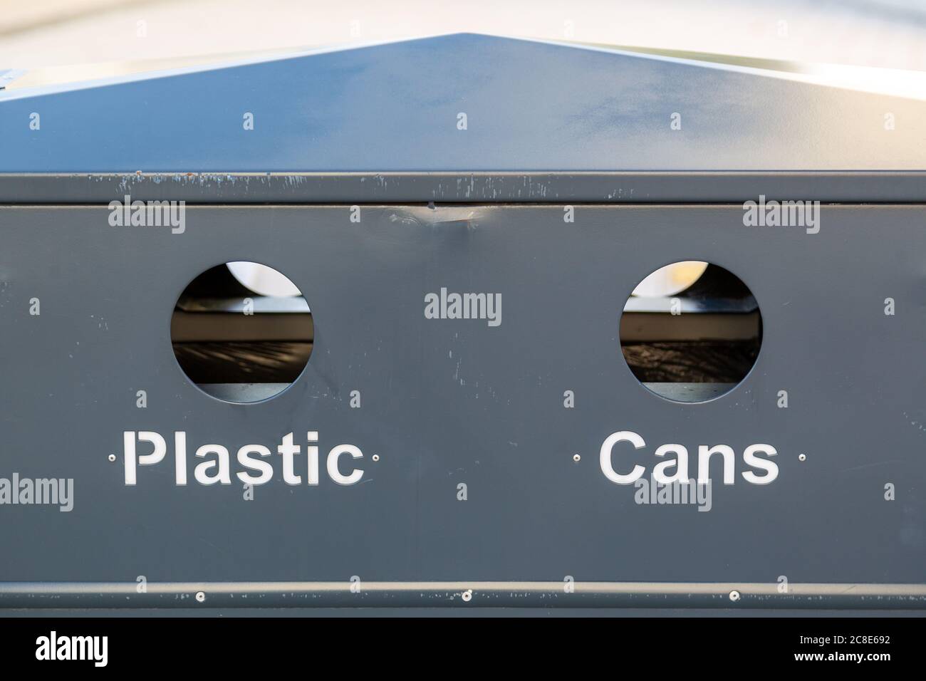 a bin with recycling holes showing cans and plastic Stock Photo Alamy