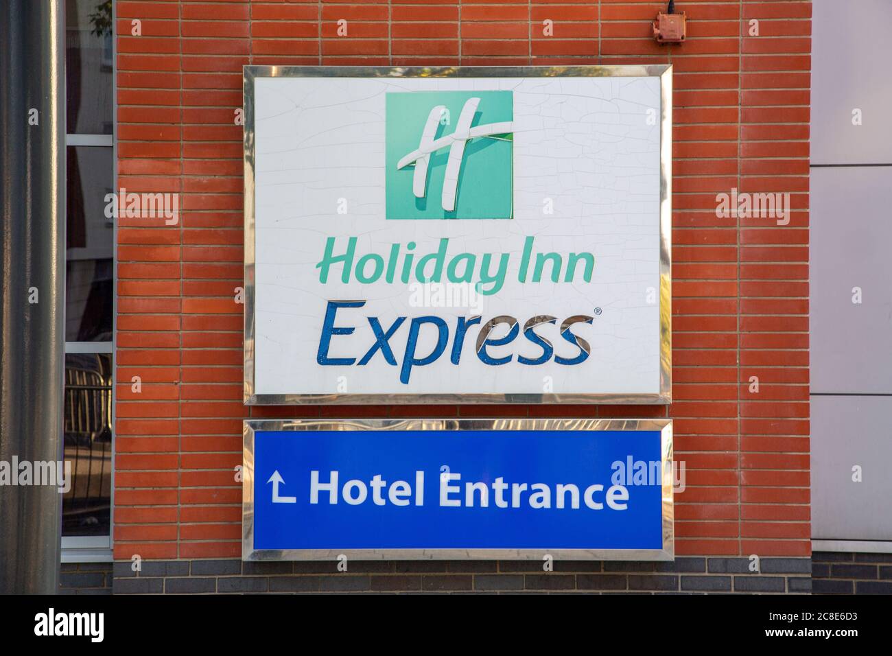 The sign of a holiday inn express hotel on the front of a hotel building Stock Photo