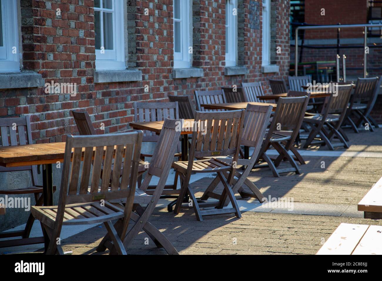 Empty outdoor tables and chairs outside a pub Stock Photo