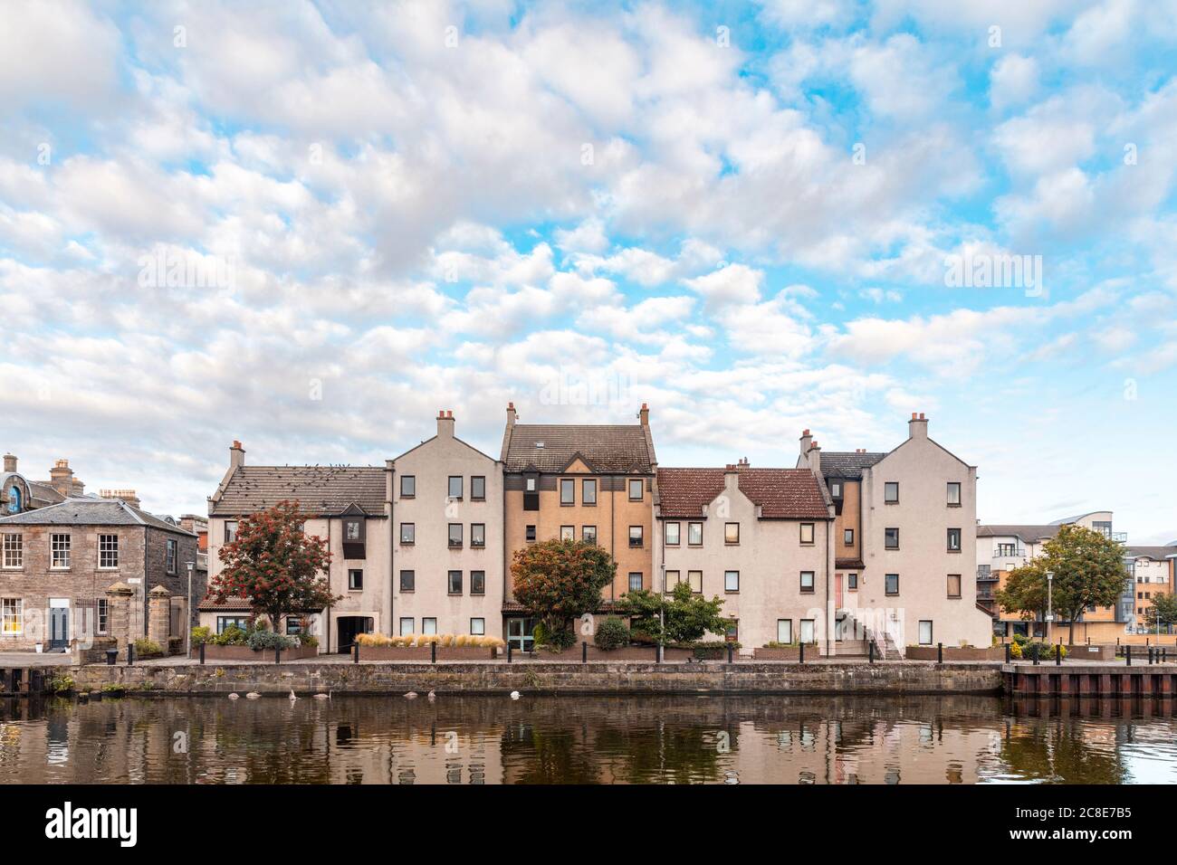 UK, Scotland, Edinburgh, Waterfront buildings and reflections on Water of Leith Stock Photo