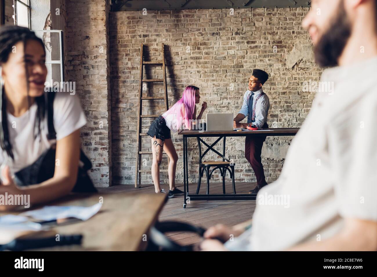 Creative team talking in loft office Stock Photo
