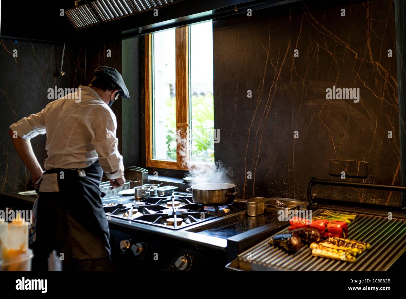 Chef preparing grilled vegetables in restaurant kitchen Stock Photo