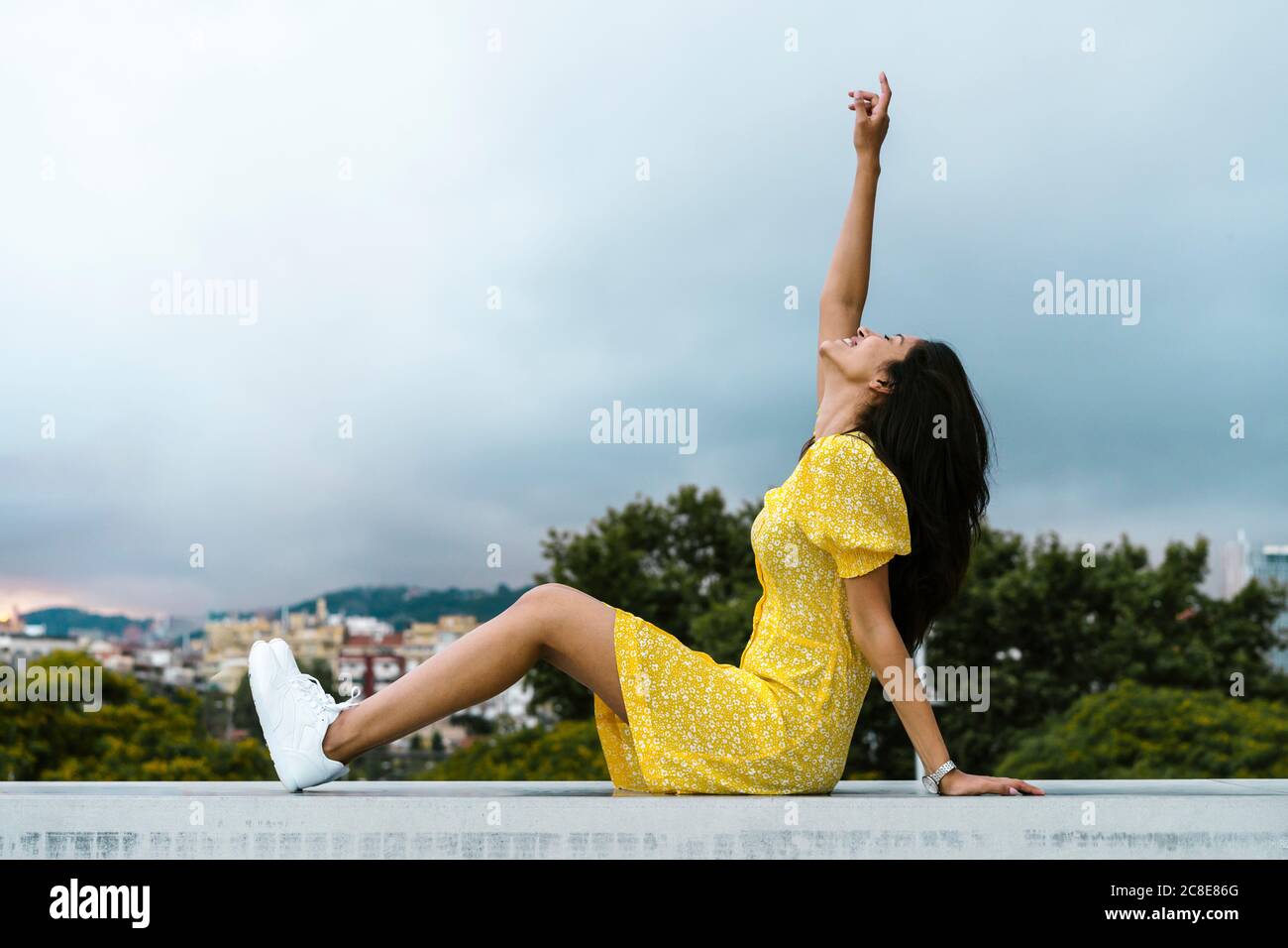 Back view woman sitting on wall hi-res stock photography and images - Alamy