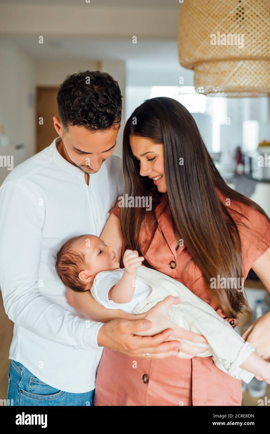 Loving parents carrying baby boy at home Stock Photo Alamy