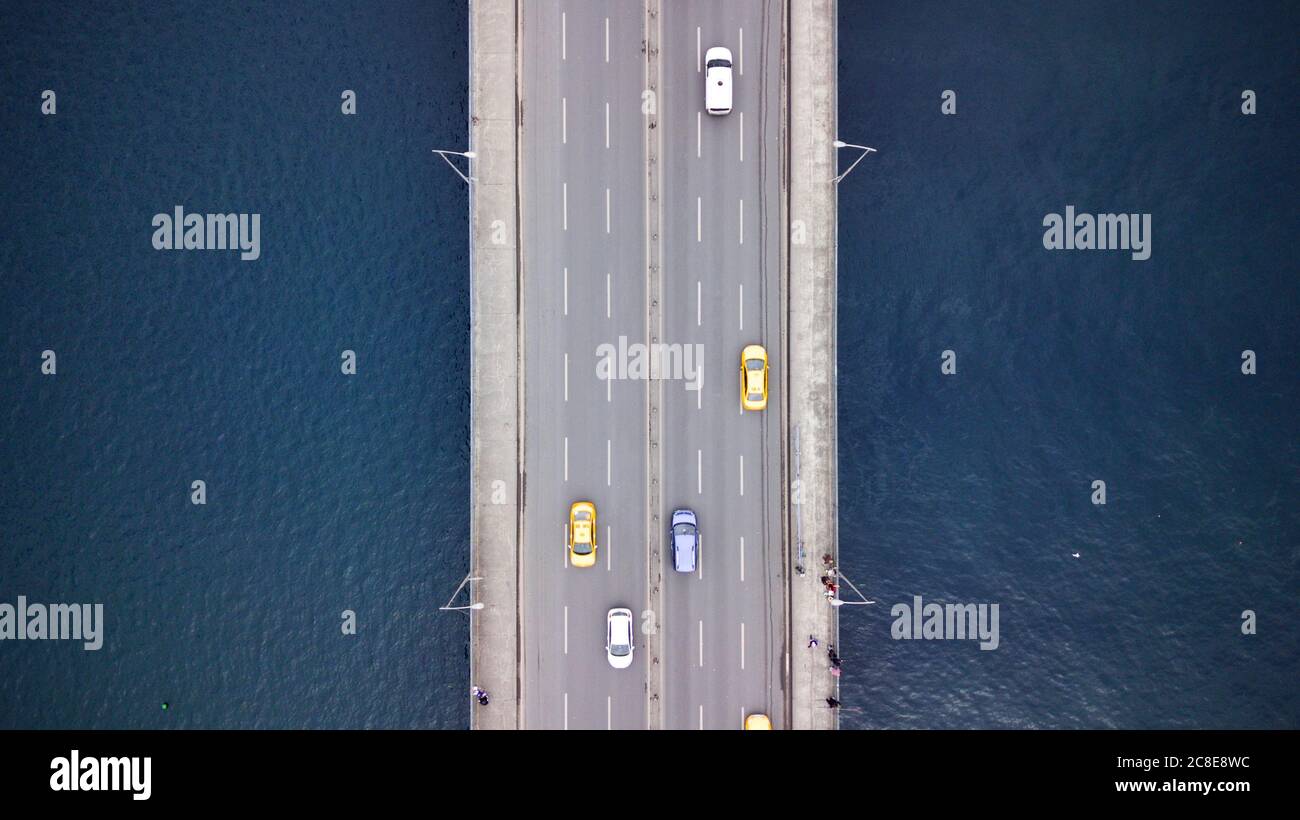 aerial view of the galata bridge at İstanbul. there is a metro station at the left bridge and the right one is galata bridge. also vehicles and cargo Stock Photo