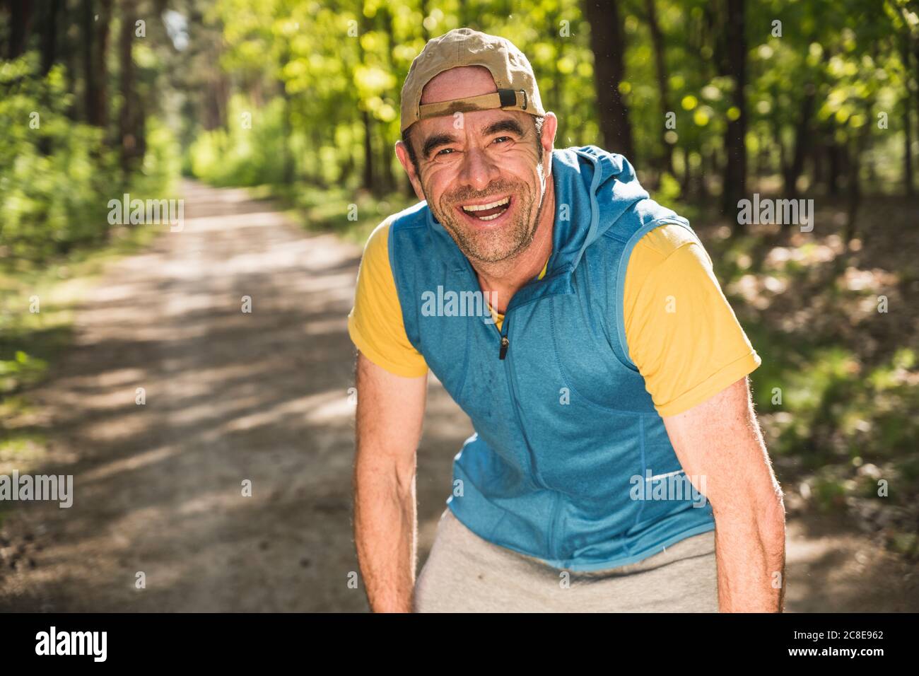 Happy mature man leaning at park Stock Photo