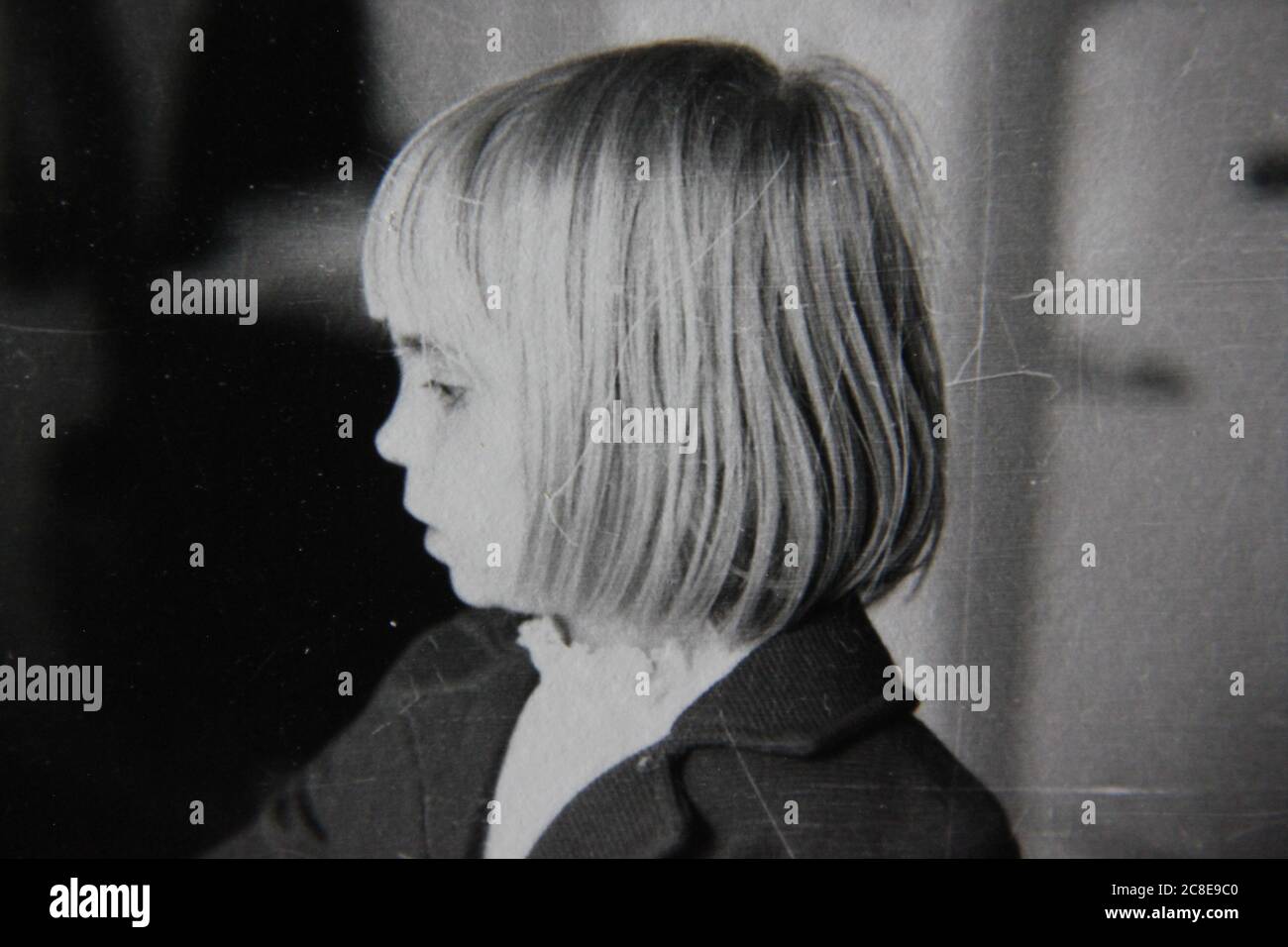 Fine 70s vintage black and white lifestyle photography of a young girl with the pageboy haircut, doggone hair. Stock Photo