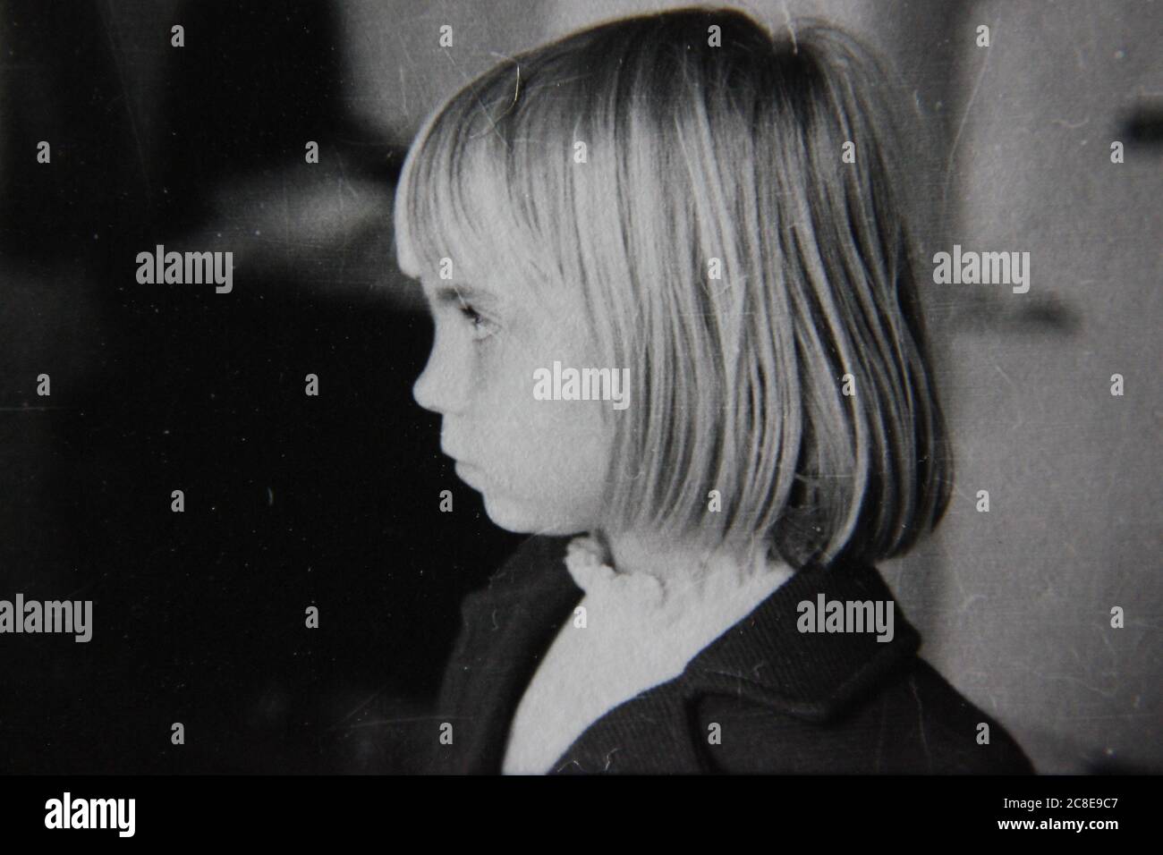 Fine 70s vintage black and white lifestyle photography of a young girl with the pageboy haircut, doggone hair. Stock Photo
