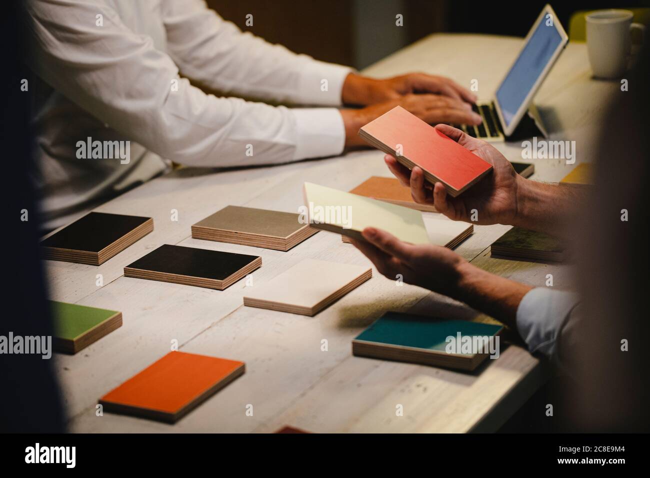 Hands of architects choosing colour samples in office Stock Photo