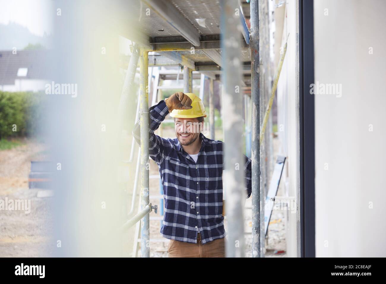Portrait of smiling worker standing on a construction site Stock Photo ...