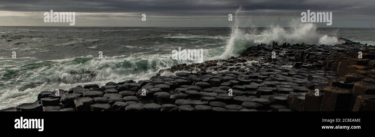 Waves crashing on the Giant's Causeway, Causeway Coast, County Antrim, Northern Ireland Stock Photo