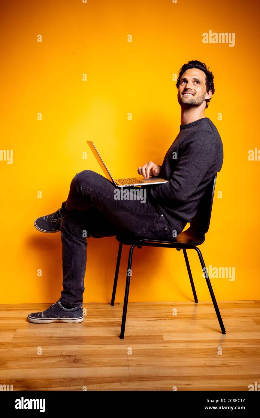 Handsome man sitting on chair hi-res stock photography and images - Alamy